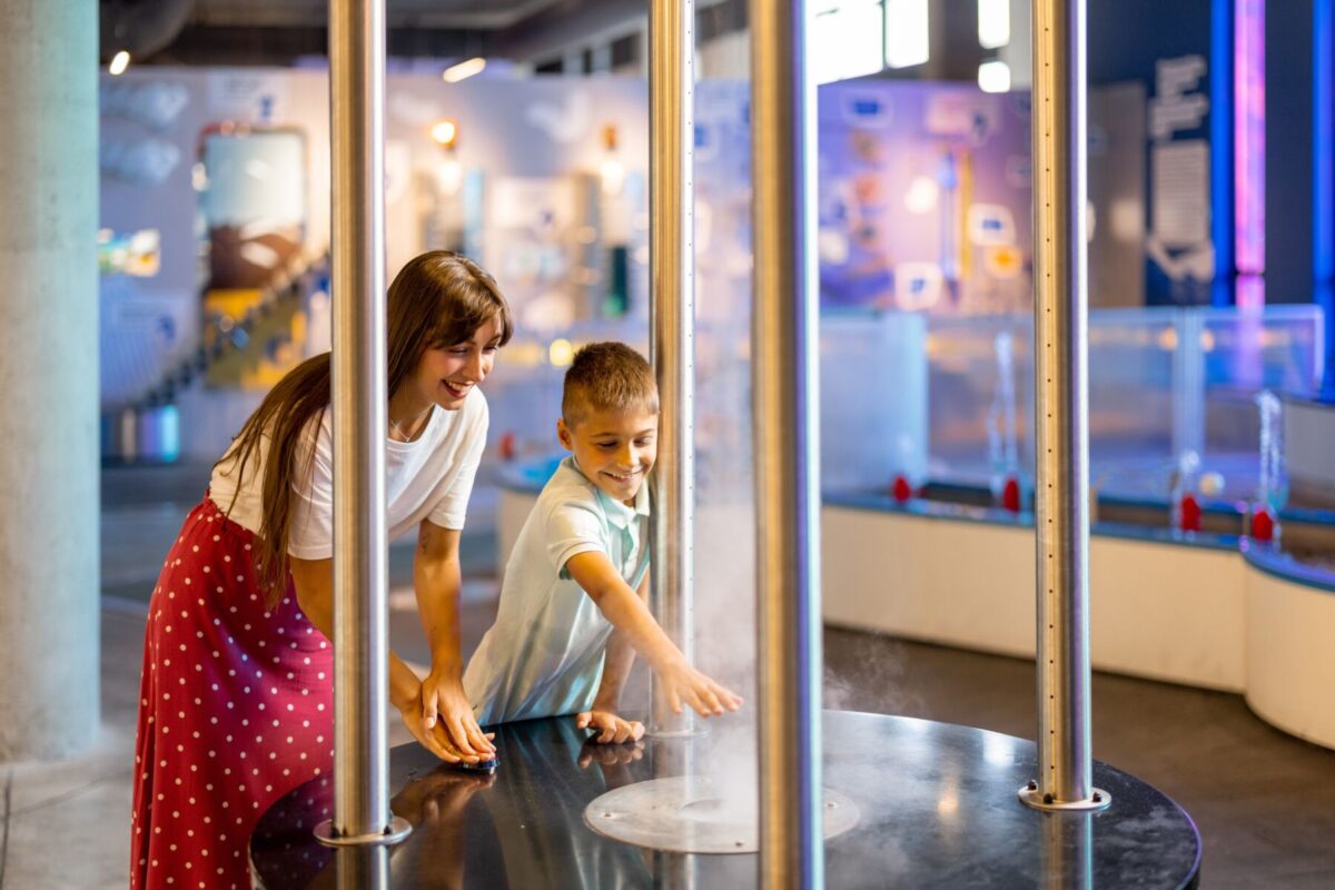 mother and son having fun at science museum
