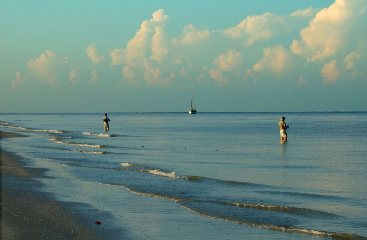 two men fishing off the gulf in fort myers beach