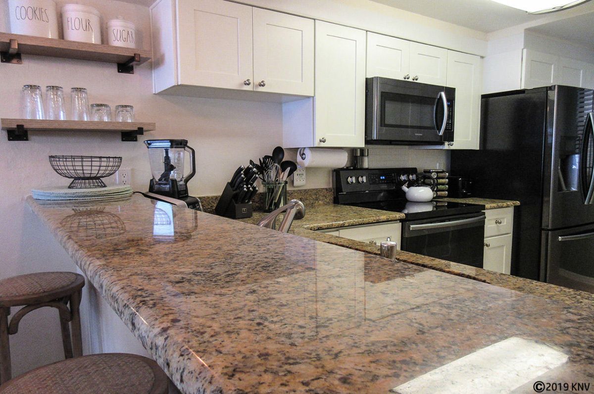 Fully equipped kitchen features granite countertops and a beautiful design.
