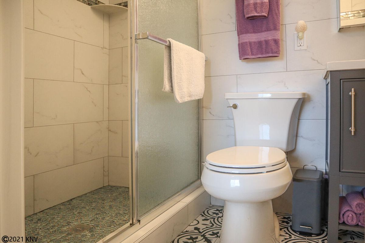 Guest Bath has Walk In Shower with beautiful glass tile