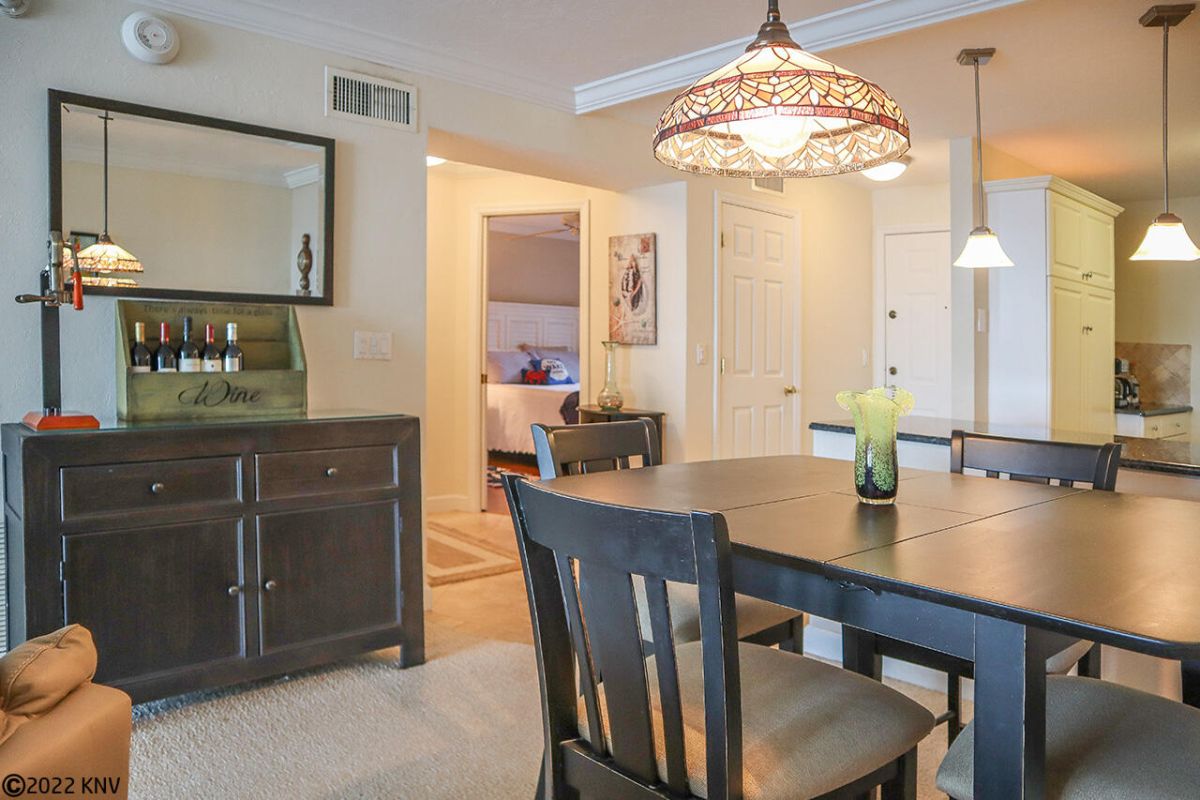 Dining Area has a serving bar credenza and high dining table
