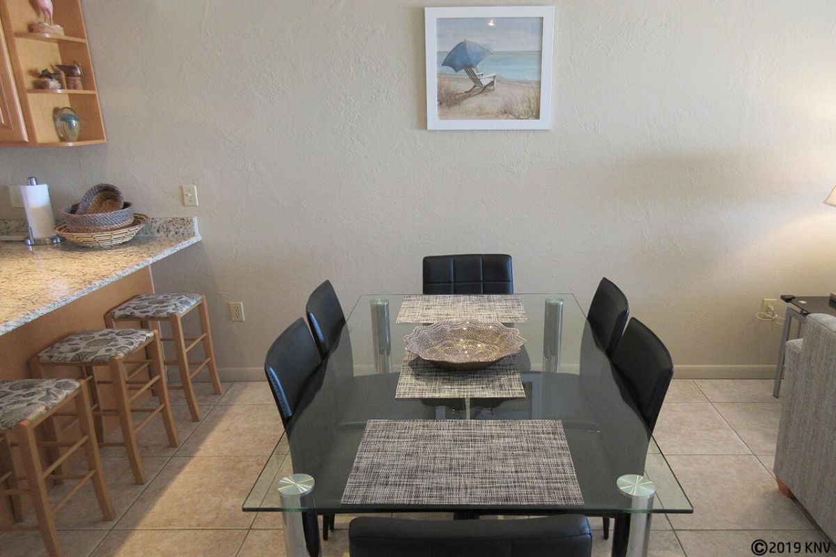 Large dining table and breakfast bar at Carlos Pointe 523