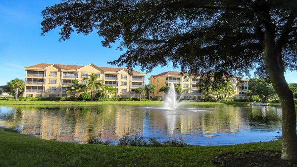 condo buildings and pond with fountain