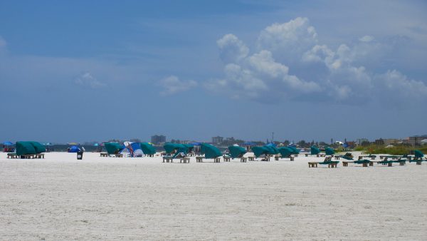 view of the beach with chairs and umbrellas