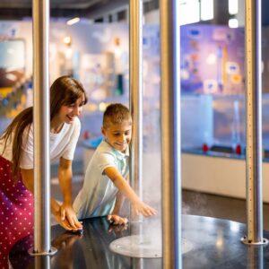 mother and son having fun at science museum
